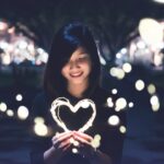 A woman holding a heart