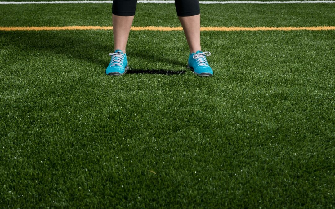 person standing on green grass field