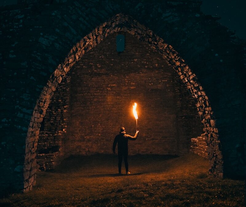 person holding torch in building interior